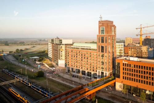 an aerial view of a city with buildings and a train at The Den, 's-Hertogenbosch, a Tribute Portfolio Hotel in Den Bosch