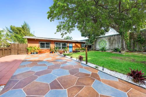 a backyard with a stone patio and a house at Unique super cozy,Bohemian Paradise with Heated Pool and positive energy in Pompano Beach