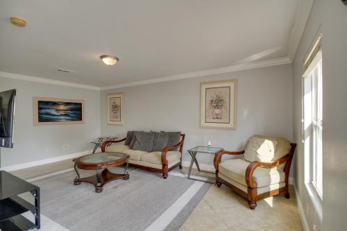 a living room with two chairs and a table at Gulfport Condo with Private Balcony - Walk to Beach! in Gulfport