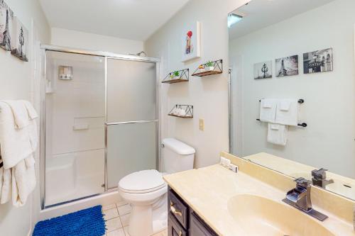 a bathroom with a shower and a toilet and a sink at Valley Retreat - Upper in Holiday Island