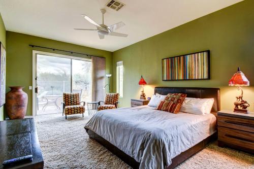 a bedroom with green walls and a bed and a patio at Arizona Vacation Rental with Private Pool and Pergola! in Phoenix