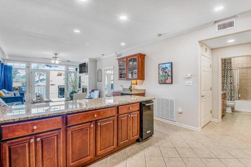 a kitchen with wooden cabinets and a counter top at Grand Getaway in Hot Springs