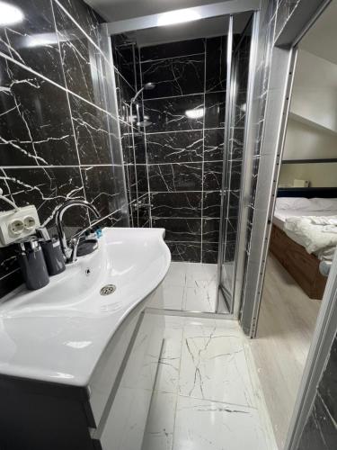 a bathroom with a sink and a shower at NEAR SUITES in Istanbul