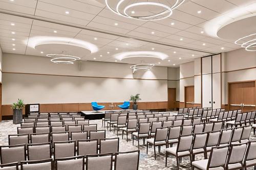 a room with rows of chairs in a room at Civic Hotel, Autograph Collection in Surrey