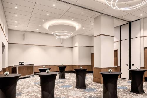 a large lobby with black stools in the middle at Civic Hotel, Autograph Collection in Surrey