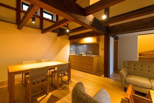 a kitchen and dining room with a table and chairs at Tsumesyo Mikuni in Sakai