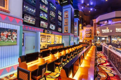 a bar with benches and televisions in a building at New York-New York in Las Vegas