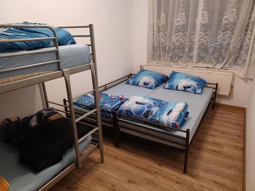 two bunk beds in a room with a window at Dom z Sauną i Jacuzzi dla dwóch rodzin Siłownia Kajaki in Gołdap