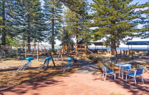 a park with a playground with chairs and tables at Central and modern 2 bedroom unit at Smugglers in Victor Harbor