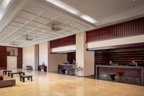 a lobby of a hotel with people sitting at desks at RIHGA Royal Laguna Guam Resort in Tamuning