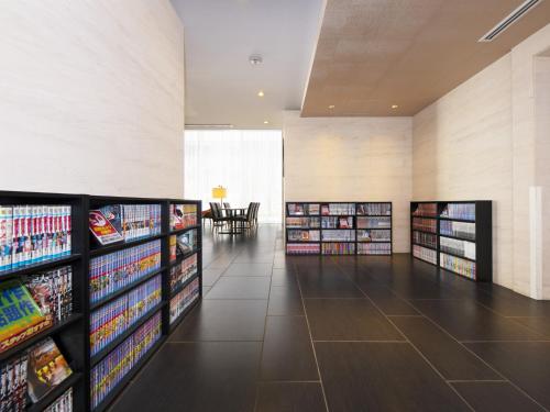 a large room with several shelves of dvds at Hotel Villa Fontaine Tokyo-hatchobori in Tokyo