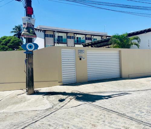 a fire hydrant on a street with a building at Apartamento encantador térreo em condomínio fechad in Porto De Galinhas