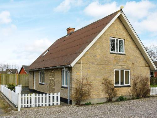 a house with a brown roof and a white fence at 6 person holiday home in Hadsund-By Traum in Hadsund