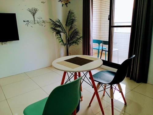 a table and two chairs in a room at Yu Hai B&B in Jiaoxi