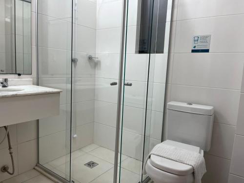 a bathroom with a shower and a toilet and a sink at Aquarius Flat Studio 509 in Santa Cruz do Sul