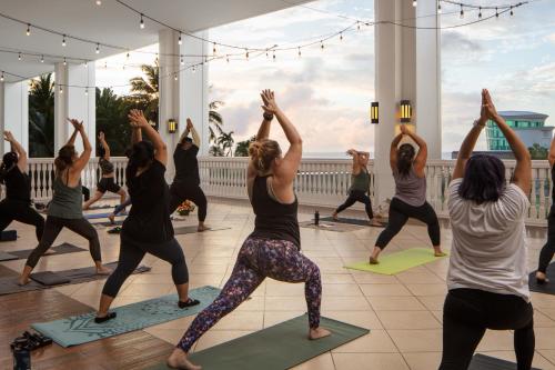 a group of people in a yoga class at RIHGA Royal Laguna Guam Resort in Tamuning