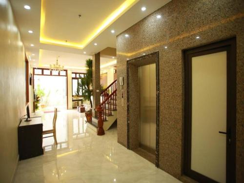 a lobby with a door and a staircase in a building at Family Airport Hotel - 5 minutes Noi Bai in Noi Bai
