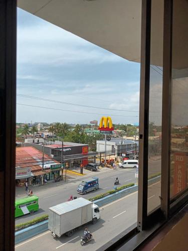 a view from a window of a city street with vehicles at Mactan Pension House in Mactan