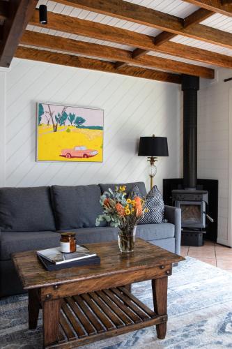 a living room with a couch and a table at Jackson Ranch by Bannisters in Bawley Point