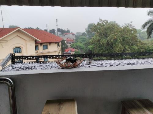 a balcony with a basket on the roof of a house at Ba Dinh Le rêveur Homestay in Hanoi
