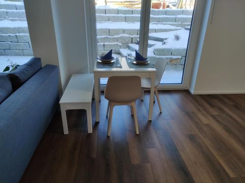 a table and chairs in a living room with a window at Ferienwohnung Eyach in Balingen