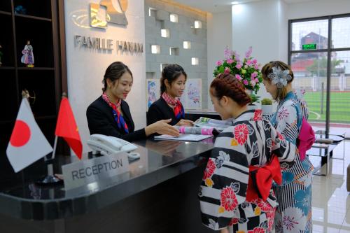 a group of three women standing at a cash register at FAMILLE HA NAM in Lưu Xá