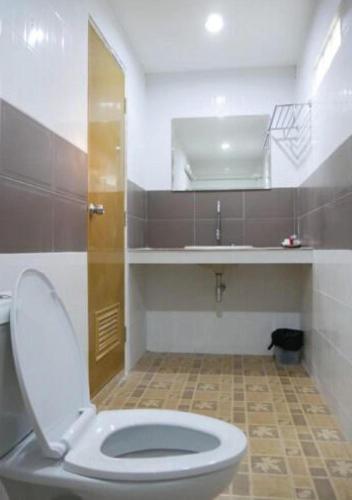 a bathroom with a toilet and a sink at Sisatchanalai Heritage Resort in Si Satchanalai