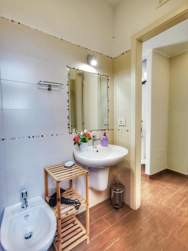 a bathroom with a white sink and a mirror at Suite 5 Monopoli in Monopoli