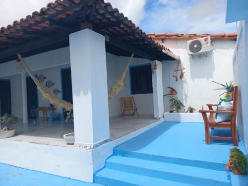 a villa with a swimming pool and a house at Pousada Recanto do Mar in Tutóia
