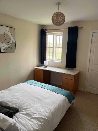 a bedroom with a bed and a window at Centralized Complete 3 BR Flat at Newcastle-Under-Lyme with a View-Free Parking in Newcastle under Lyme