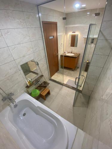 a bathroom with a sink and a glass shower at FAMILLE HA NAM in Lưu Xá