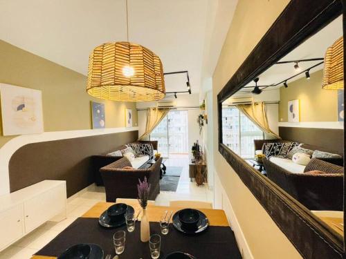 a living room with a dining table and a living room at 8 pax Homestay near Axiata Arena & Pavilion 2 in Kuala Lumpur