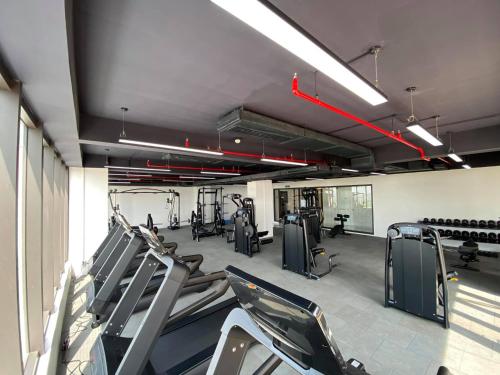 a gym with treadmills and elliptical machines at FAMILLE HA NAM in Lưu Xá