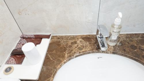 a bathroom with a sink and a toilet with a counter at FAMILLE HA NAM in Lưu Xá