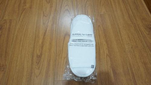 a white skateboard in a plastic bag on a wooden floor at FAMILLE HA NAM in Lưu Xá