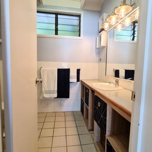 a bathroom with a sink and a mirror at Island Serenity on Magnetic Island in Nelly Bay
