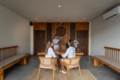 a group of women sitting at a table in a room at Teratai Villa Canggu by Ini Vie Hospitality in Canggu