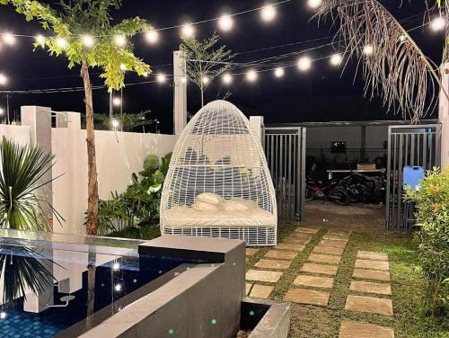 a white bird in a bird cage in a garden at Hidden Haven Subic Villa w/ Infinity Pool in Subic