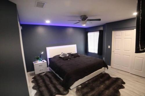 a bedroom with a bed and a ceiling fan at Las Vegas Oasis in Las Vegas