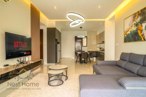 a living room with a couch and a tv at Country Garden Seaview Suite by Nest Home at Danga Bay in Johor Bahru