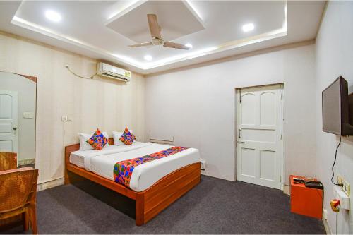 a bedroom with a bed and a tv in it at FabHotel Saltlake Regency in Kolkata