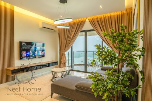 a living room with a couch and a tv at Country Garden Seaview Suite by Nest Home at Danga Bay in Johor Bahru