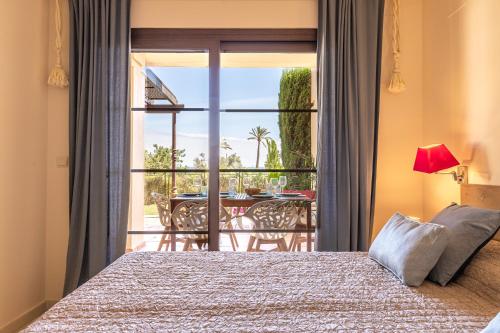 a bedroom with a bed and a view of a patio at BELLA GADEA in Altea