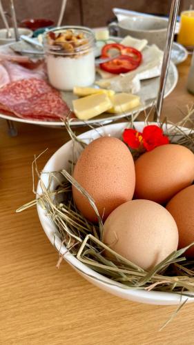 a table with plates of eggs on a table at Almdorf Omlach, Fanningberg in Weisspriach