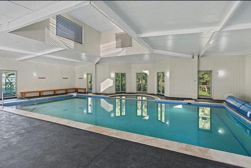 a large swimming pool in a large room with at Discover St Georges Basin in St Georges Basin