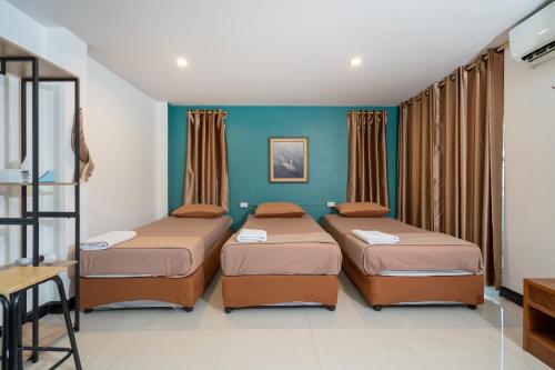 a bedroom with two beds in a room at Black Pantera Hostel in Patong Beach