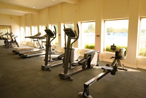 a gym with several tread machines in a room at Sun Hotel and Resort, Mount Abu in Ābu Road