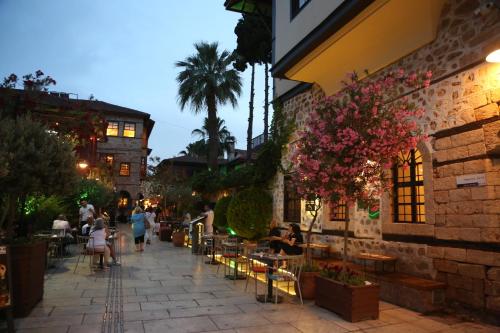 a group of people walking down a sidewalk at Gazetta in Antalya