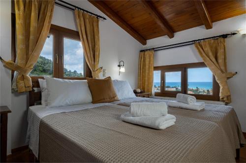 A bed or beds in a room at Villa Eleftheria private pool/garden/view/3bdrms/3.5bthrms