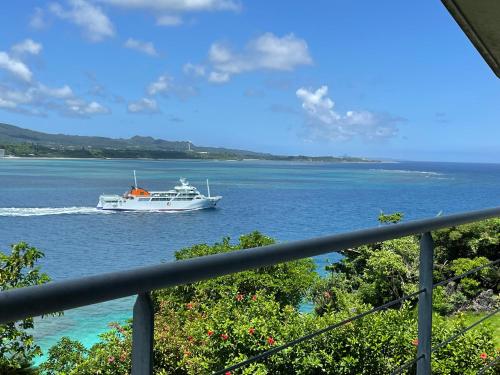a boat in a large body of water at 古宇利ゲストハウス1835 in Kouri